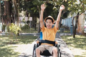 asian special need child on wheelchair raise arms 2022 11 11 21 52 58 utc - Akim Deutschland e.V.